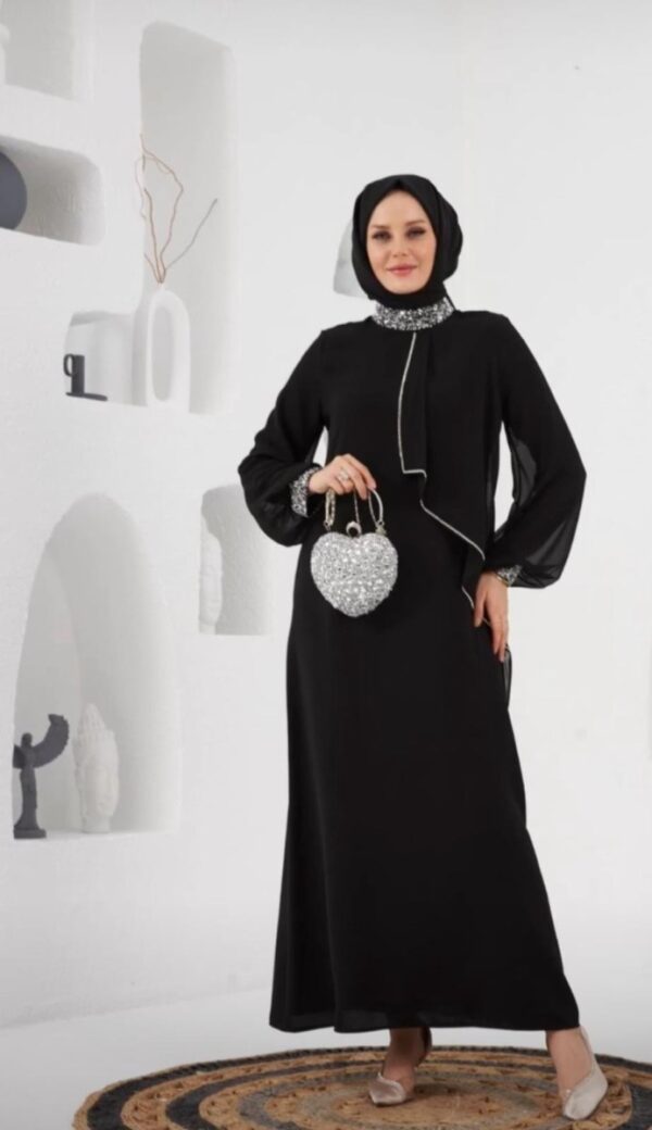 Black Crepe Evening Hijab Dress displayed on a mannequin, featuring a sophisticated and modest design, available at Noor Boutique in the GTA.