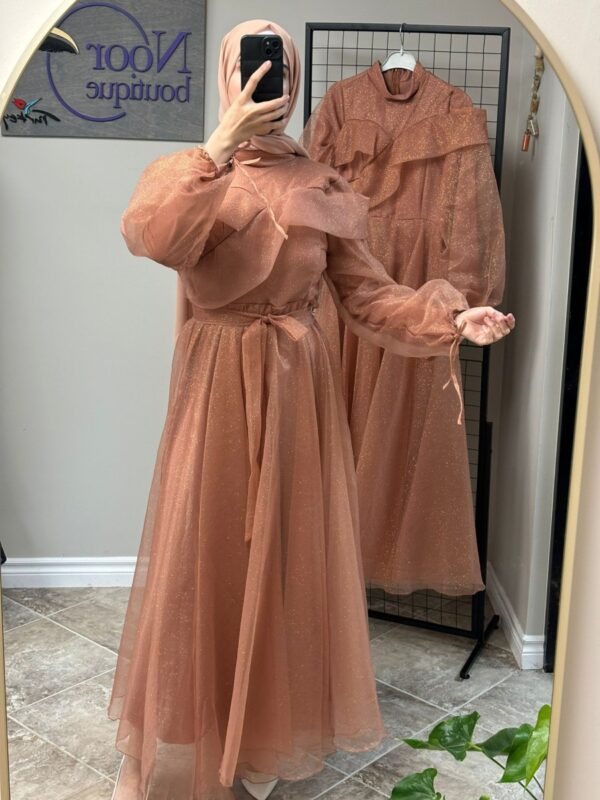 Peach Princess Hijab Dress worn by a model, showcasing a graceful and modest design, available at Noor Boutique in the GTA.